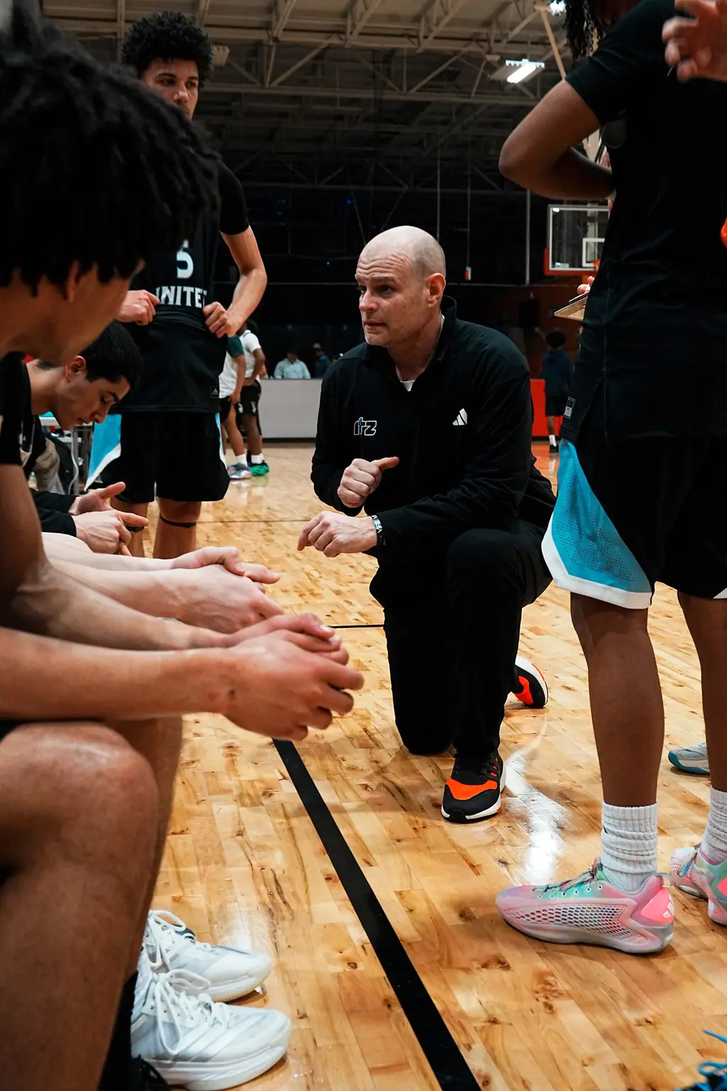 Coach speaking with players during a team huddle