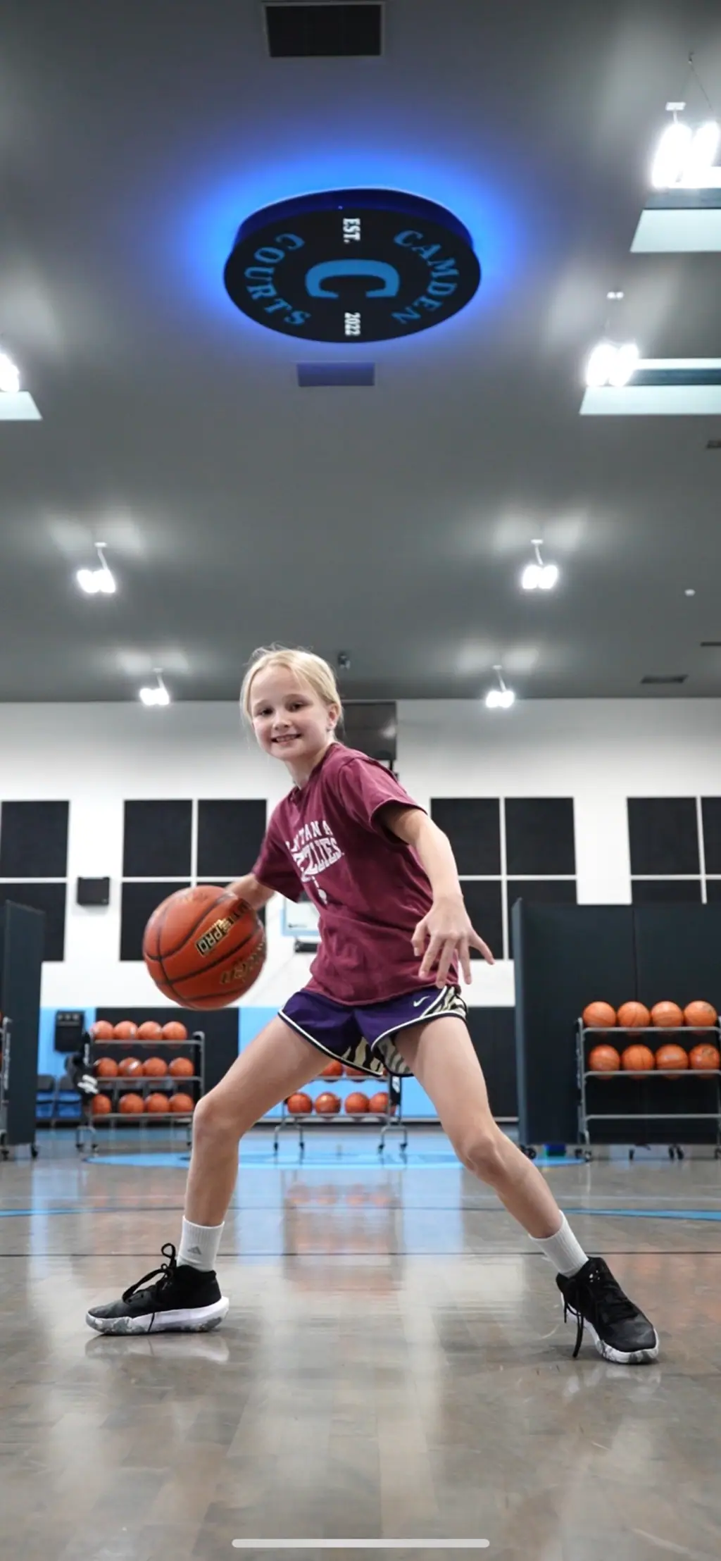 A young athlete working a dribbling drill