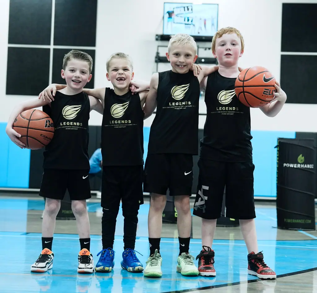 Four young players posing together