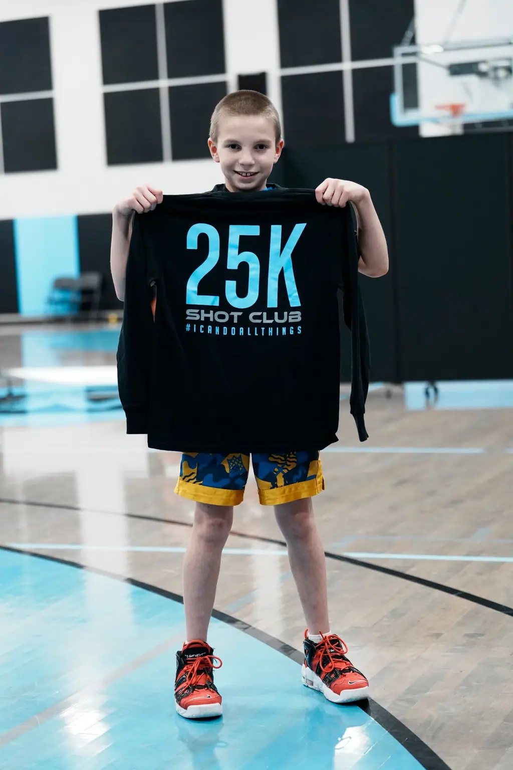 Player holding a 25K milestone shirt