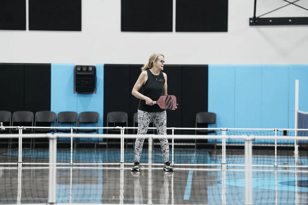 Player ready across the pickleball net