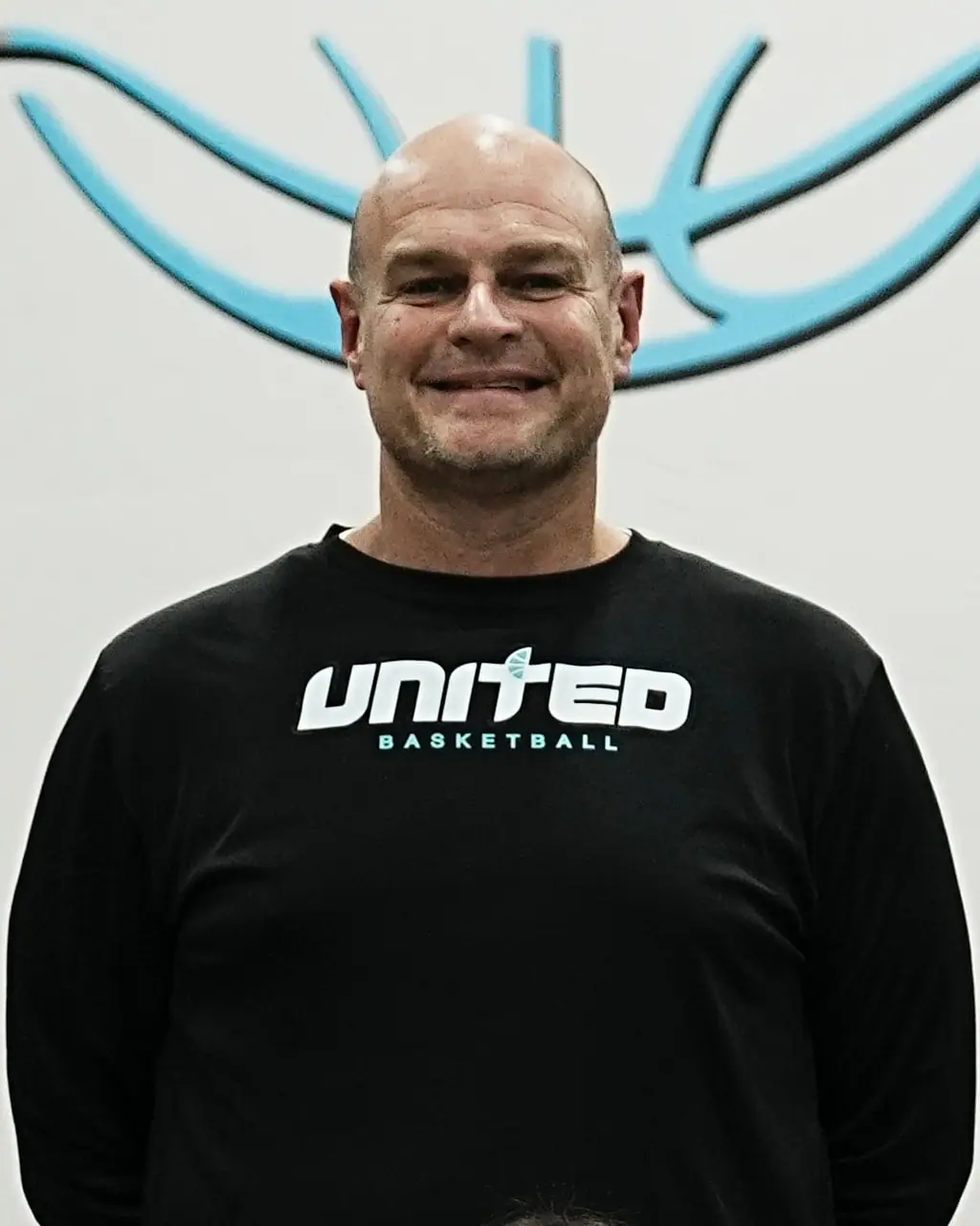 Smiling coach in a United shirt