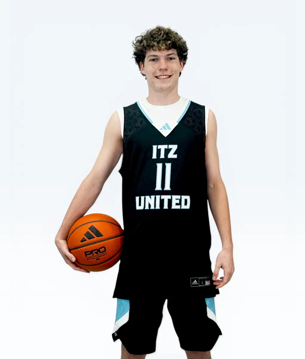 Smiling player holding a ball, jersey 11