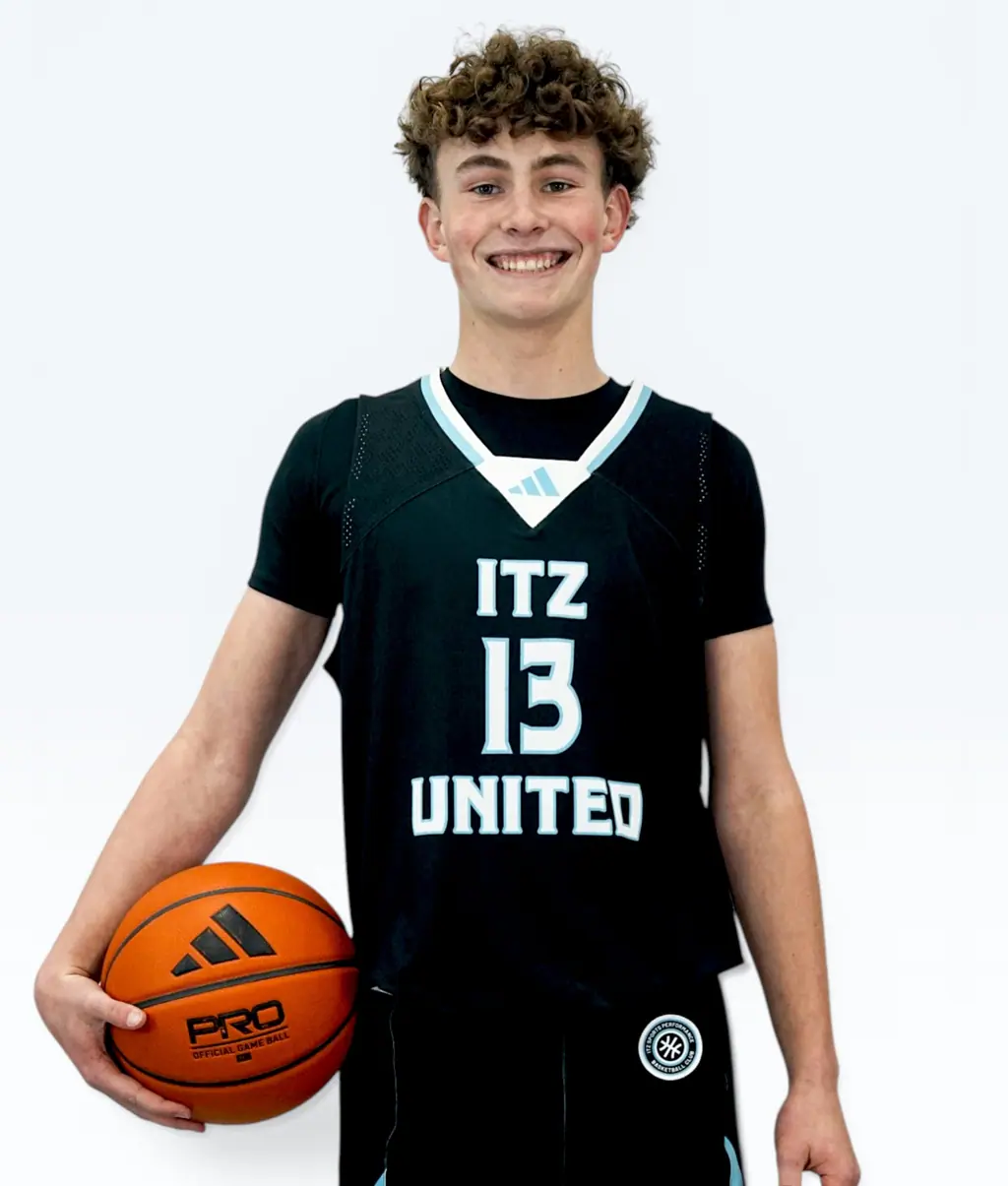 Smiling player holding a ball, jersey 13