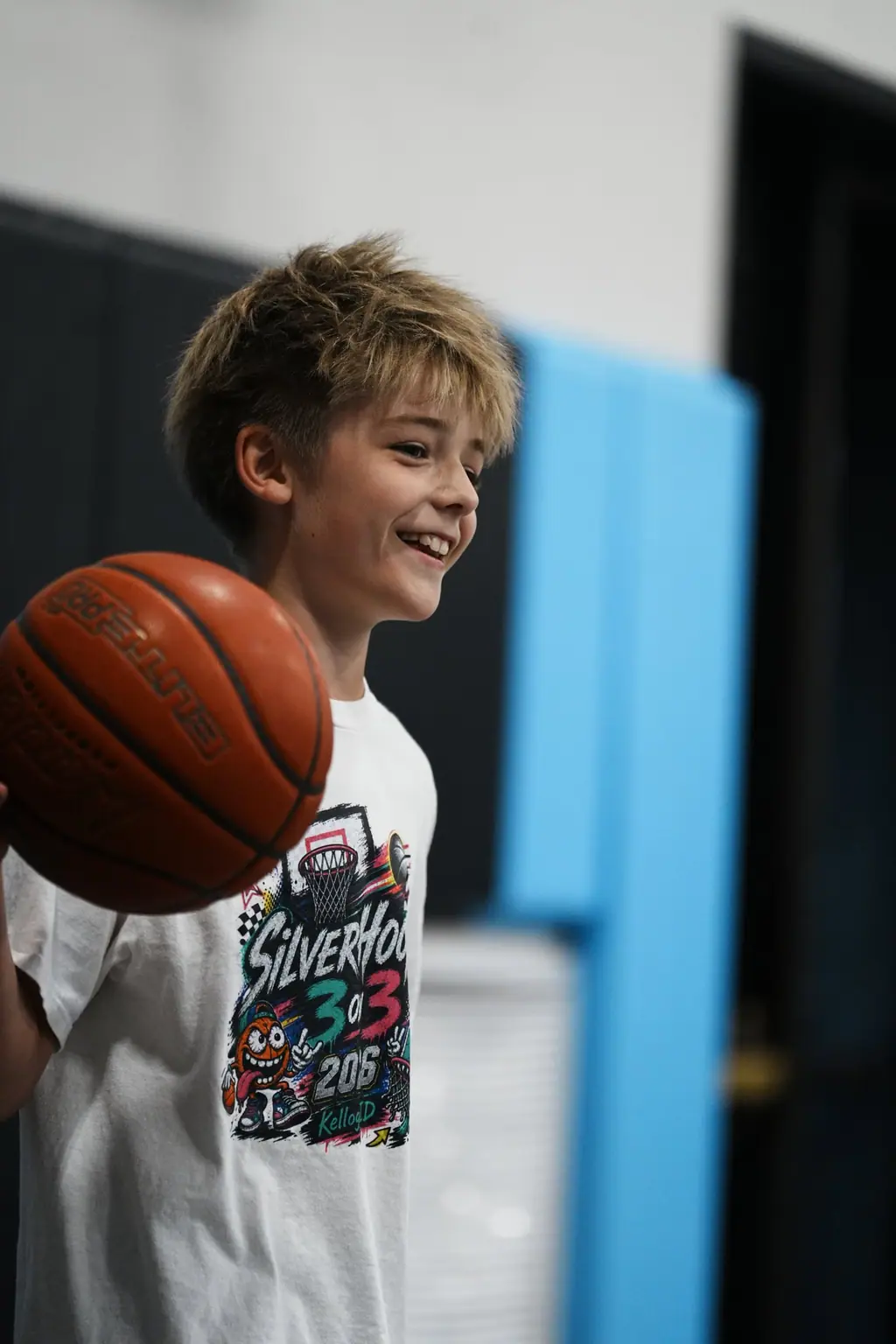 Young player smiling with a ball