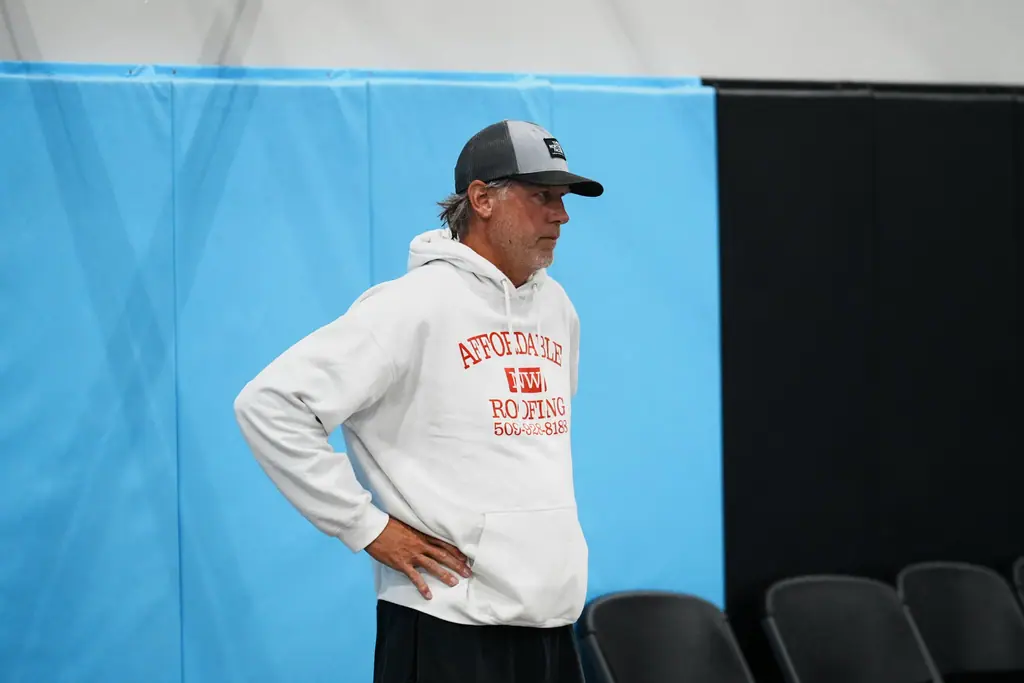 Coach watching from beside the court