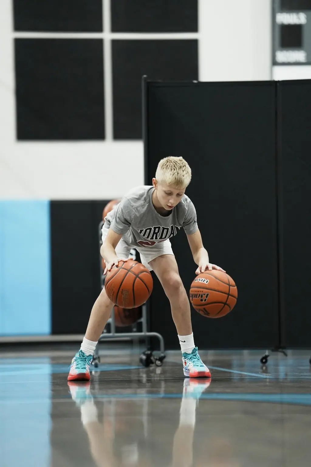 Player working with two basketballs